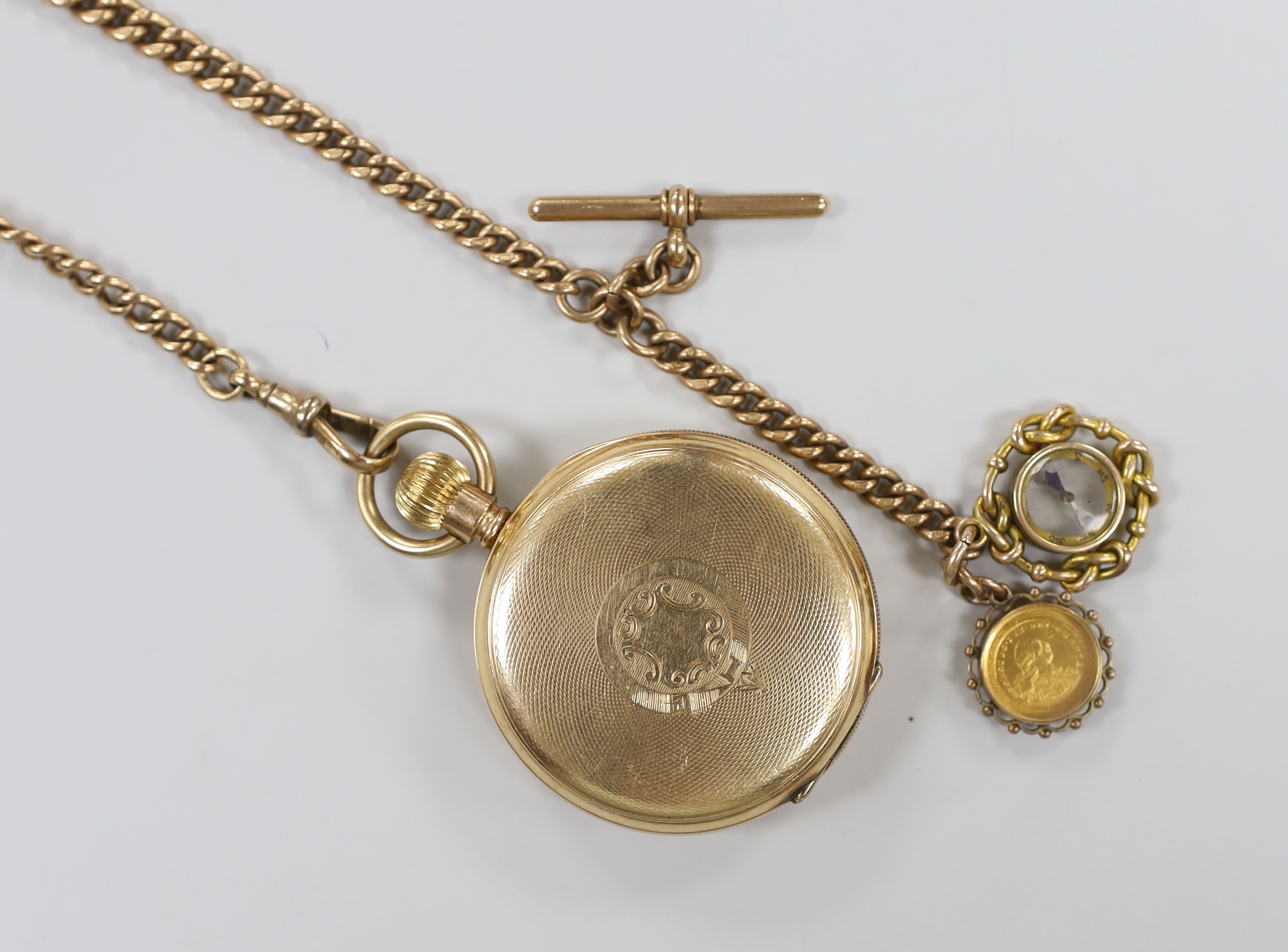 A Waltham gold plated open face pocket watch, with Roman dial and subsidiary seconds, on a 9ct gold albert hung with two fobs including compass, albert gross 54.5 grams.